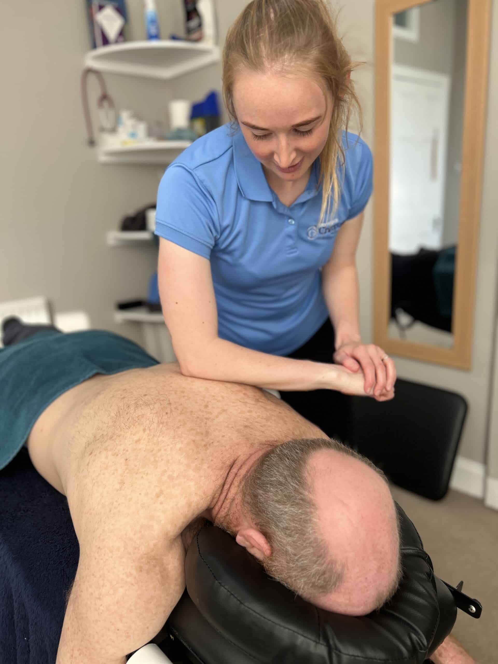 Female Massage therapist working on a client's back